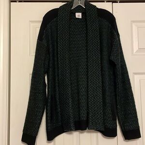 Size large Cabi black and green patterned sweater with pockets.
